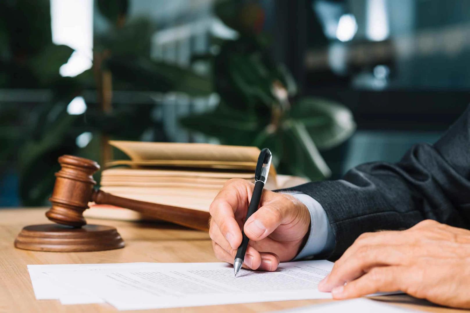 judge-holding-pen-checking-document-wooden-deskdg